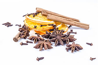 Cinnamon Sticks, Star Anise, Cloves, and Orange Slices on White Background