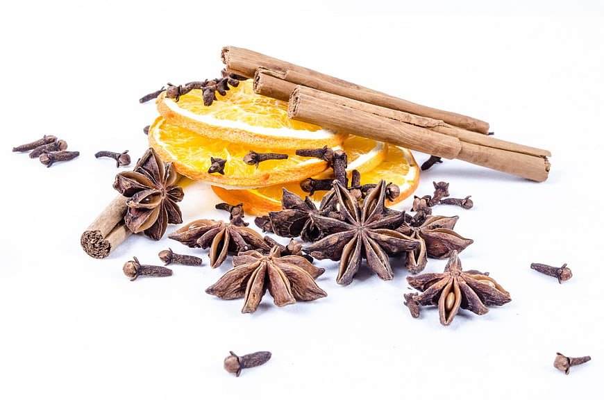 Cinnamon Sticks, Star Anise, Cloves, and Orange Slices on White Background