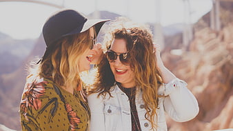Two Happy Women Laughing Together Outdoors in Sunlight