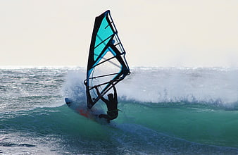 Windsurfer riding a wave on the ocean