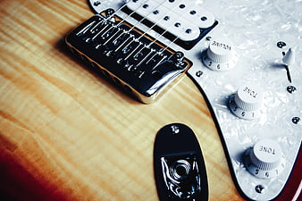 Close-up of Electric Guitar Body with Pickups and Knobs