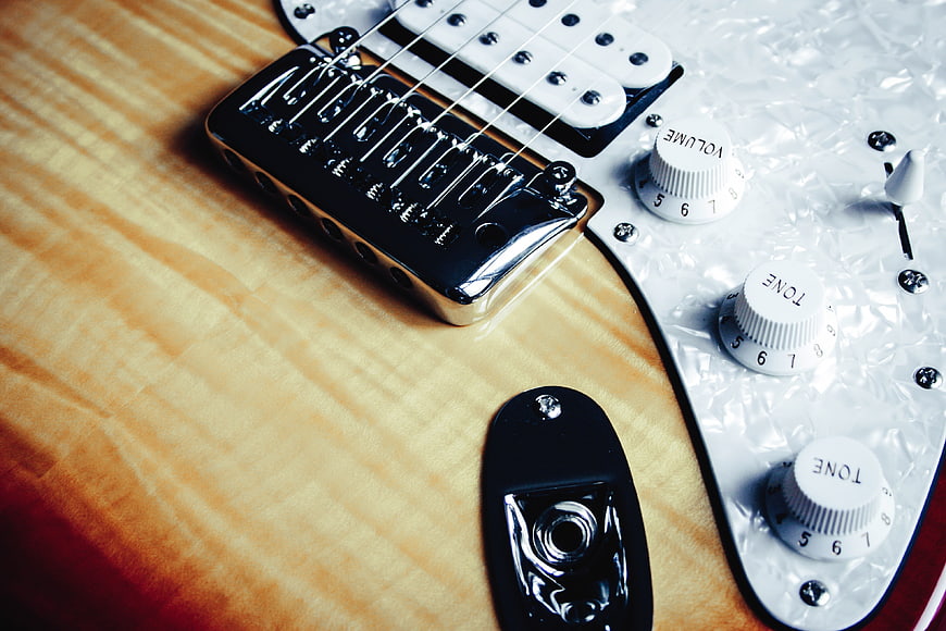 Close-up of Electric Guitar Body with Pickups and Knobs