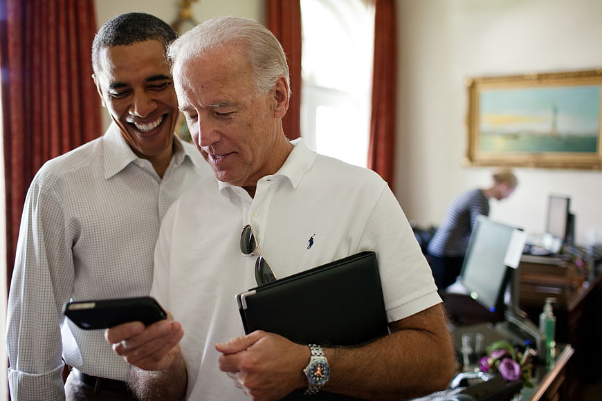 Barack Obama and Joe Biden Sharing a Moment with a Smartphone