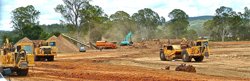 Heavy machinery operating at a large earthmoving construction site
