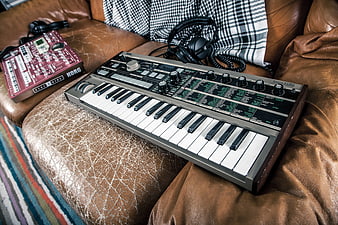 Korg MicroKorg Synthesizer on Leather Sofa