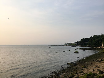 Serene Coastal Landscape with Rocky Shoreline and Calm Water