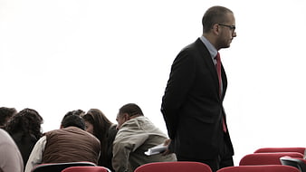Businessman Walking Past Seated Audience In Conference Hall