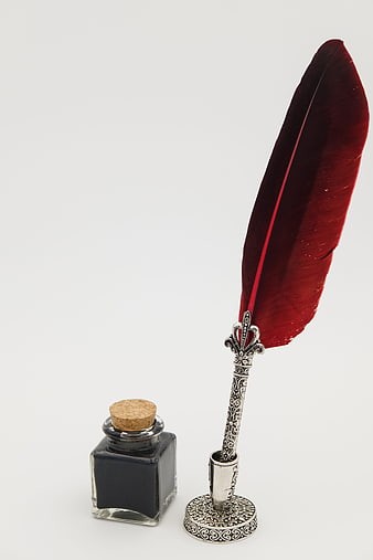 Red Feather Quill Pen and Inkwell on White Background