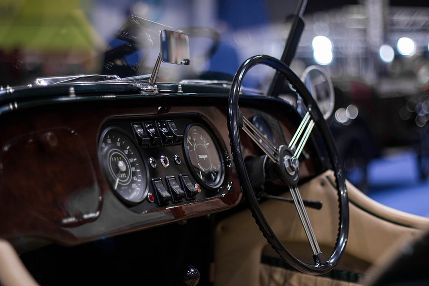 Vintage Car Interior with Wooden Dashboard and Steering Wheel
