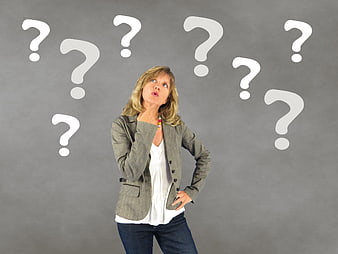 Confused businesswoman thinking with question marks overhead