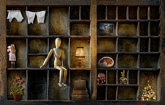 Melancholic wooden mannequin sitting in a rustic grid shelf with vintage objects