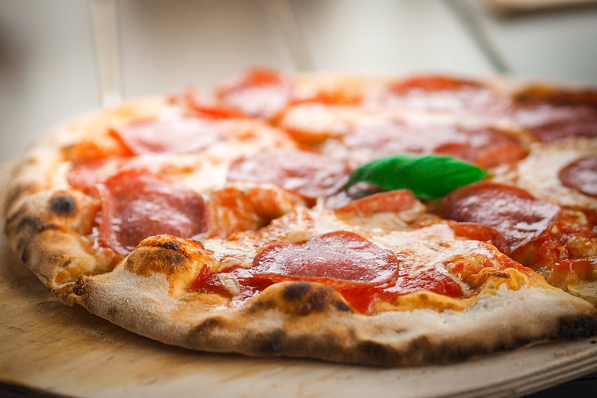 Close-up of freshly baked pepperoni pizza on wooden board