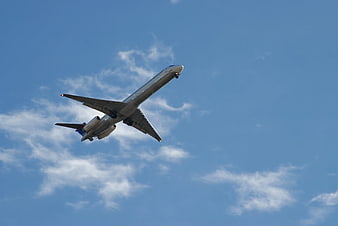 Commercial Airplane Taking Off Against Blue Sky