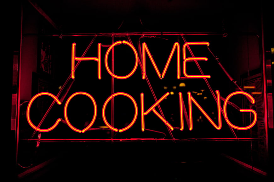 Red Neon Home Cooking Sign in Dark Setting