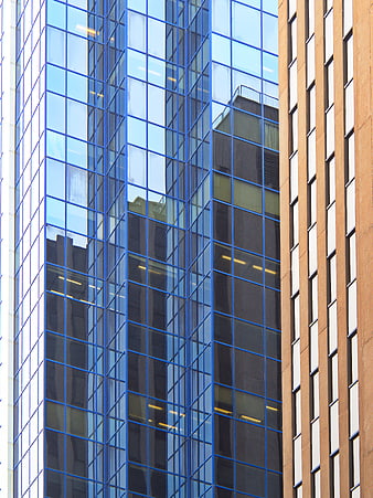 Modern Glass Skyscraper Facade with Blue Reflections