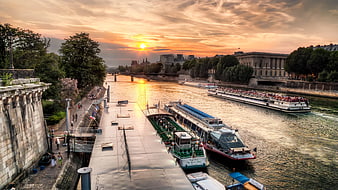 Sunset over Paris Seine River with Tour Boats