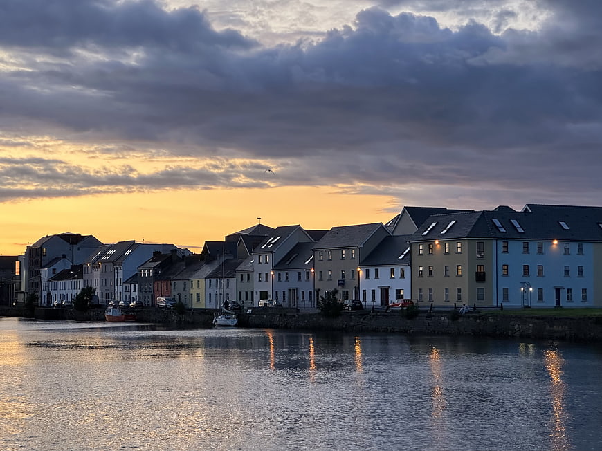 Colorful European Waterfront Town At Dusk With Dramatic Clouds