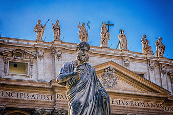 St. Peter's Basilica facade with statues and blue sky