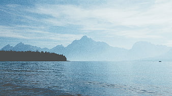 Serene Lake Landscape with Distant Mountains and Forested Shore