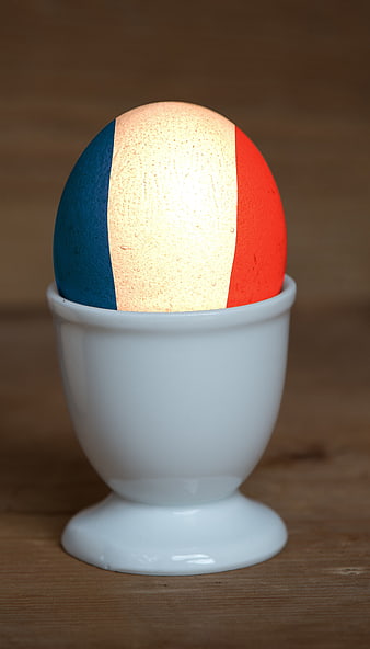 Easter egg painted with French flag in white egg cup