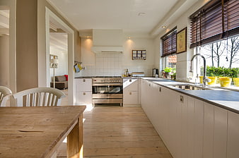 Bright Modern Kitchen with Wooden Table and White Cabinets
