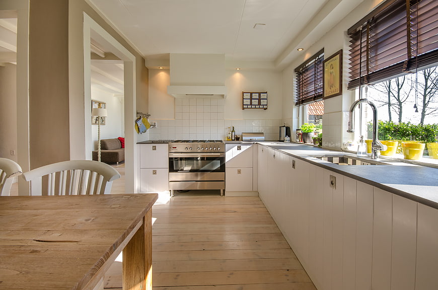 Bright Modern Kitchen with Wooden Table and White Cabinets