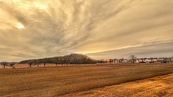 Dramatic Cloudy Sky Over Rural Field and Village