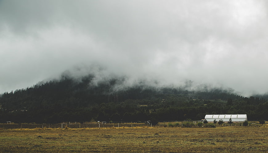 Misty Mountain Landscape with Foggy Forest and Field
