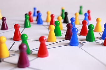 Colorful game pieces on network diagram representing teamwork