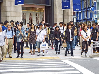 Crowd of pedestrians crossing a busy street in Tokyo, Japan