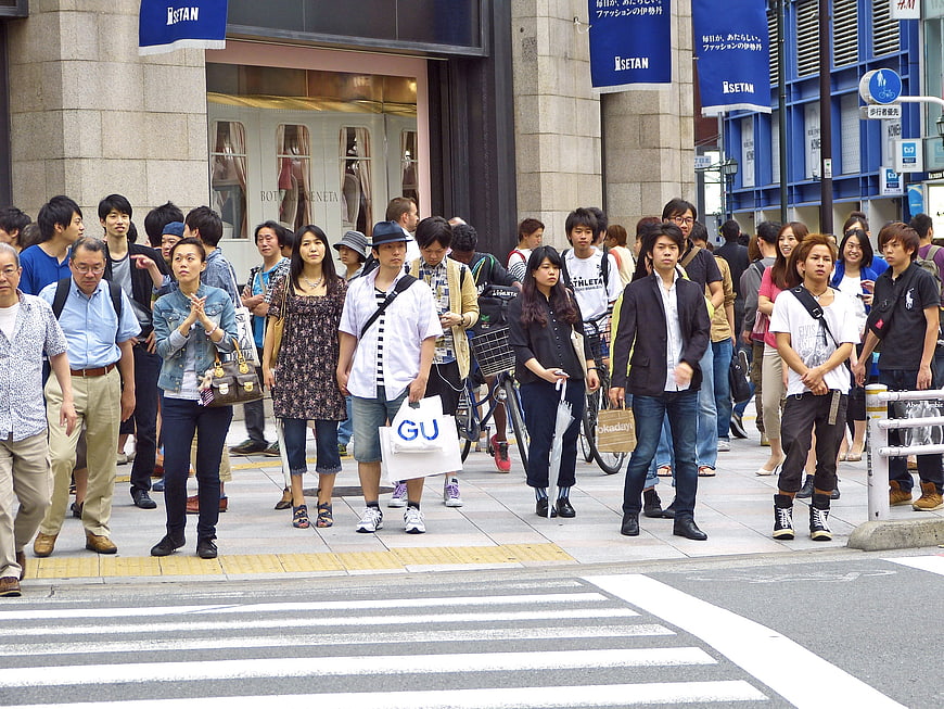 Crowd of pedestrians crossing a busy street in Tokyo, Japan