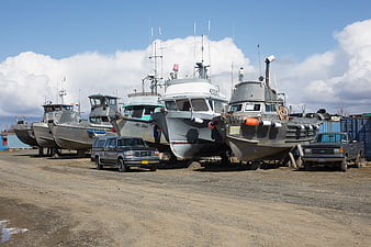 Fleet of fishing boats parked in dry dock boatyard