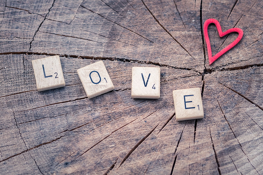 Scrabble Tiles Spelling Love on Rustic Wood with Red Heart
