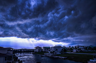 Dramatic Storm Clouds Over Waterfront Homes