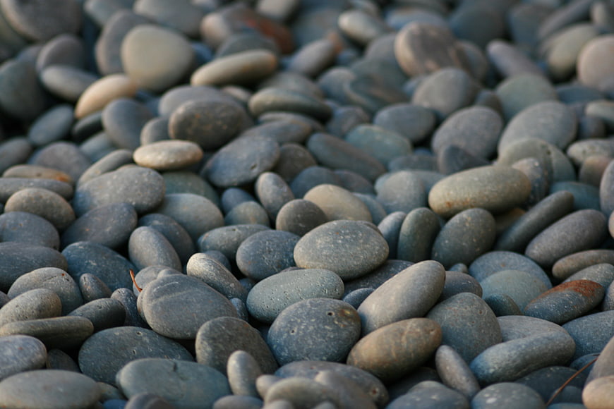 Close-up of smooth gray river stones and pebbles