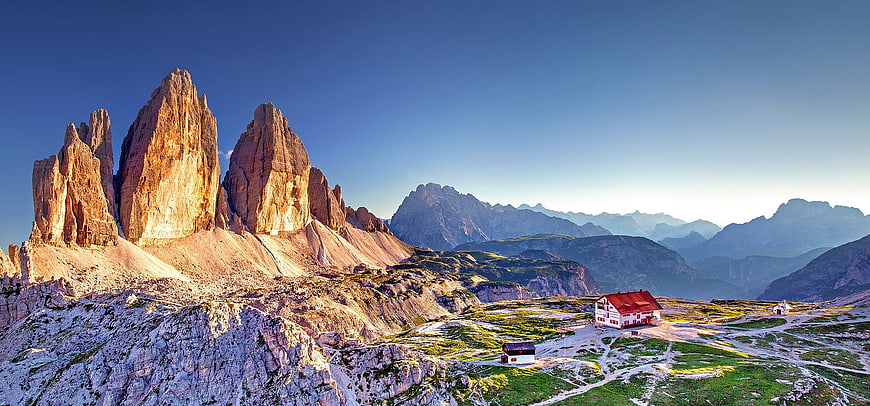 Dramatic Dolomites Mountain Panorama with Alpine Cabin at Golden Hour