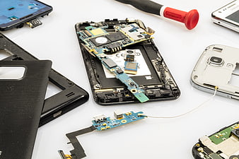 Disassembled Smartphone Internal Components and Repair Tools