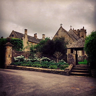 Historic stone church with garden and stone wall