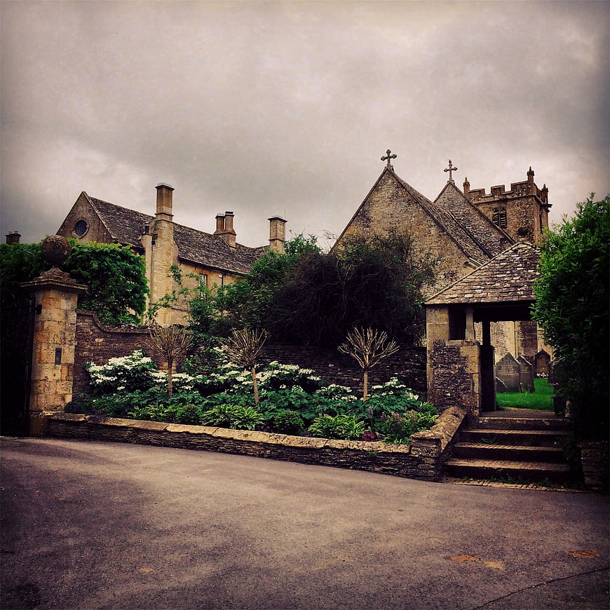 Historic stone church with garden and stone wall