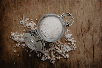 Top view of Himalayan pink salt in glass jar on wood