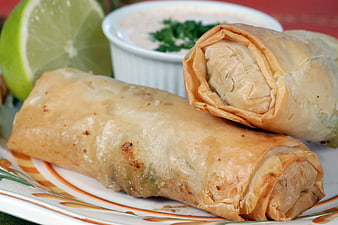Crispy Egg Rolls With Lime Wedge And Dipping Sauce