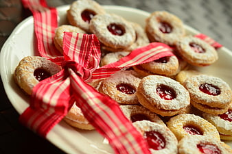 Christmas Linzer Cookies With Red Ribbon On White Plate