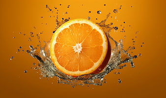 Fresh Sliced Orange with Water Splash on Orange Background