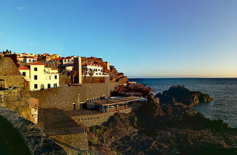 Coastal village architecture on rocky cliffs overlooking the ocean
