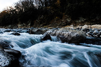 Long Exposure Flowing River with Smooth Water and Rocks