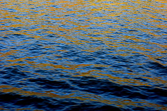 Shimmering blue and gold water texture background