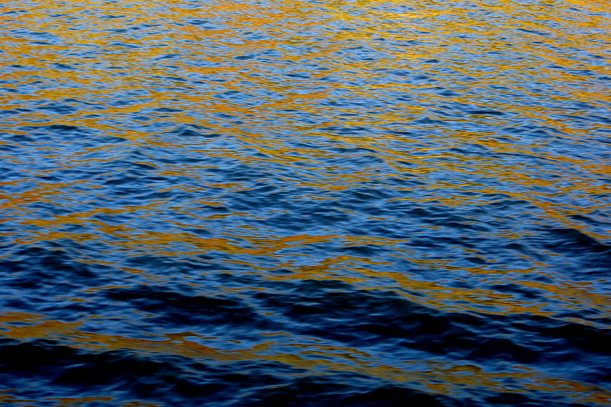 Shimmering blue and gold water texture background