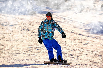 Snowboarder in Blue Plaid Jacket on Snowy Slope