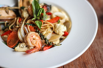 Seafood Pasta Dish With Shrimp, Squid, and Fresh Basil Garnish