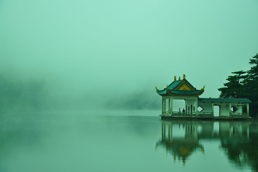 Traditional Chinese Pavilion on Misty Lake at Dawn